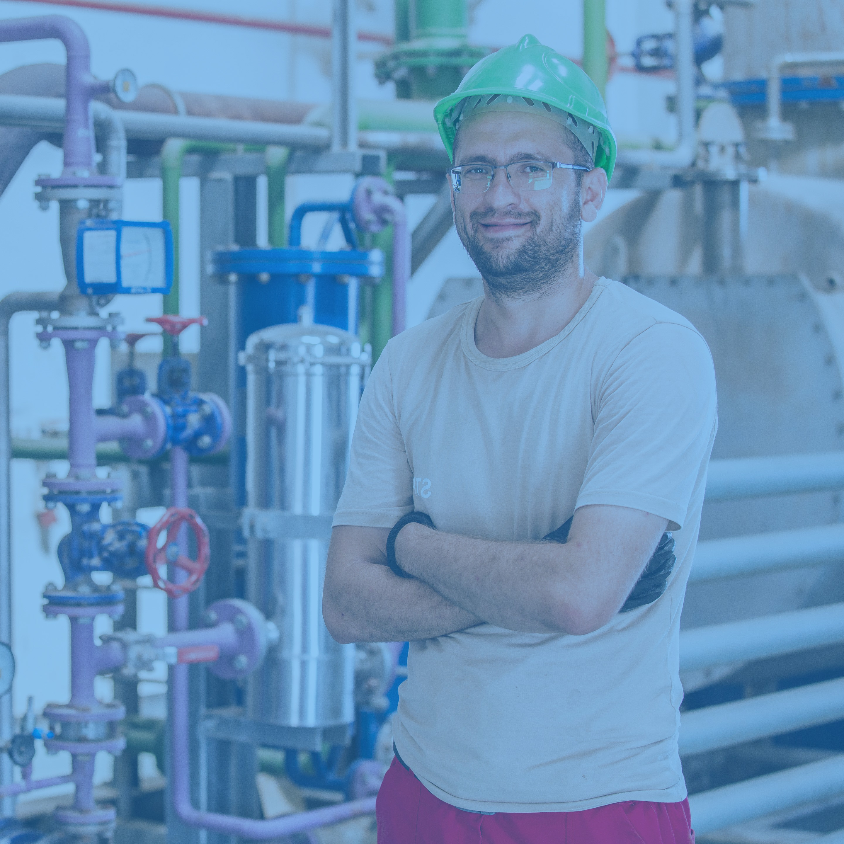 industry-worker-posing-inside-factory-with-bars-pipes-around - Copy 1