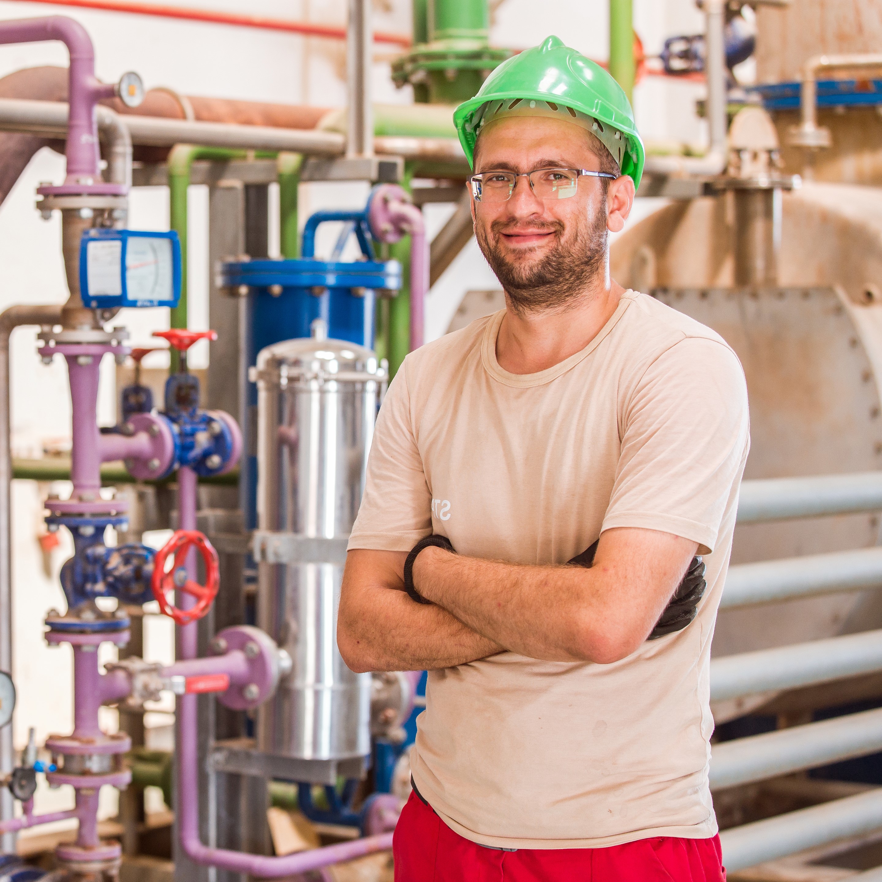 industry-worker-posing-inside-factory-with-bars-pipes-around - Copy